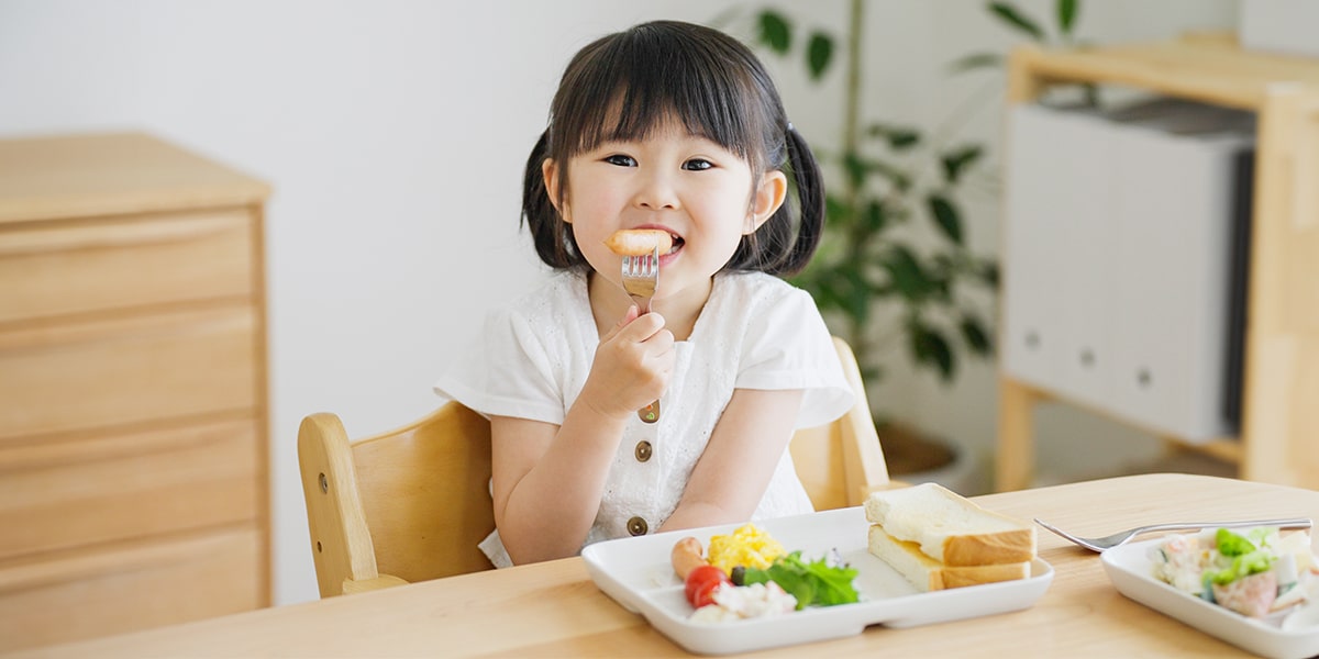 A child eating food at a table