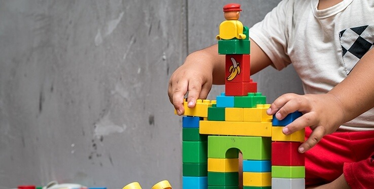 Child playing with a toy building set