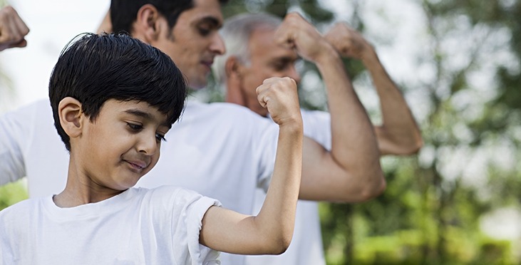 Grandfather, Father And Son Flexing Muscles