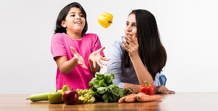 Mother and daughter with vegetables